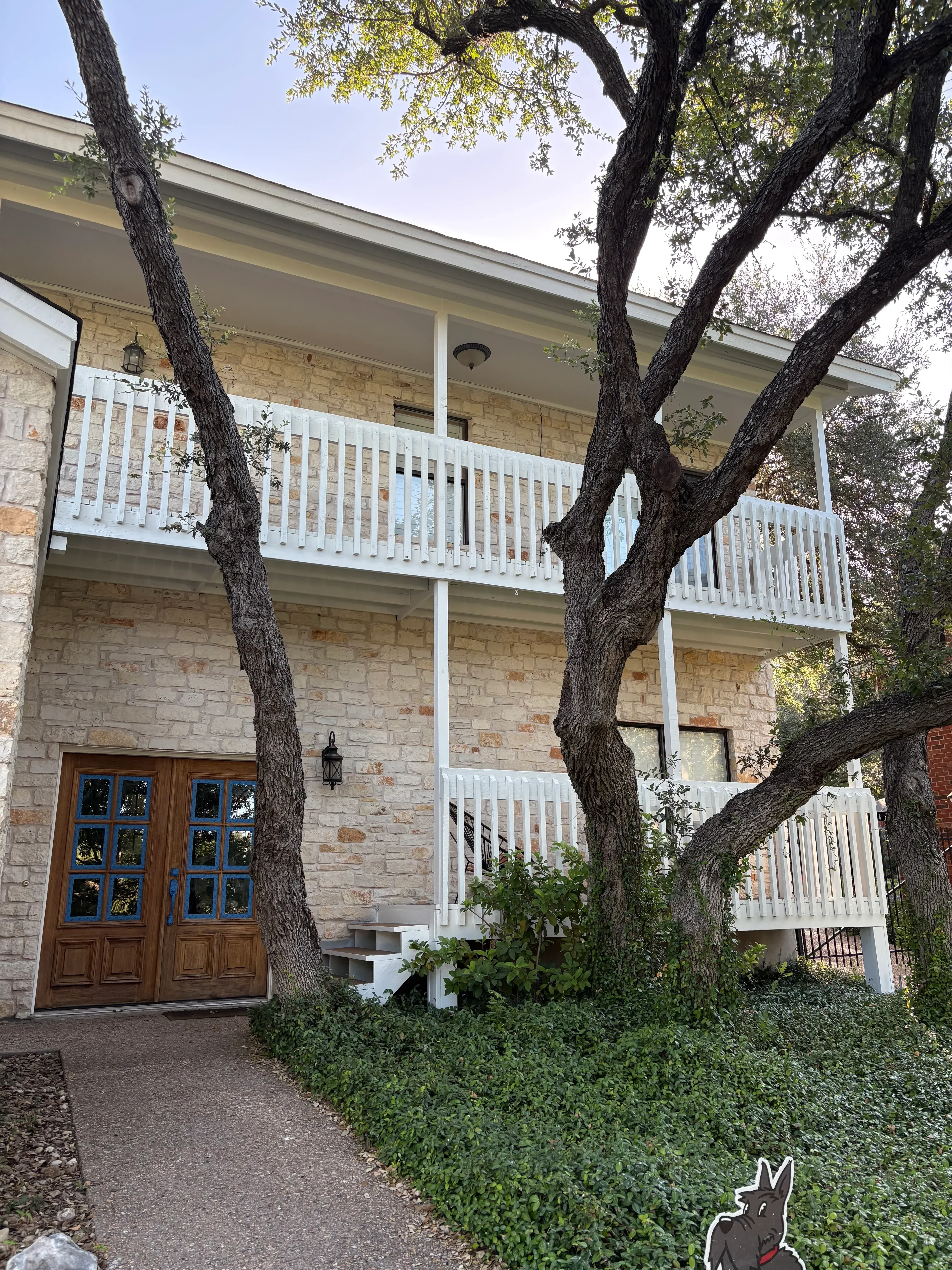 Exterior house with white-painted shutters and trim on brick facade
