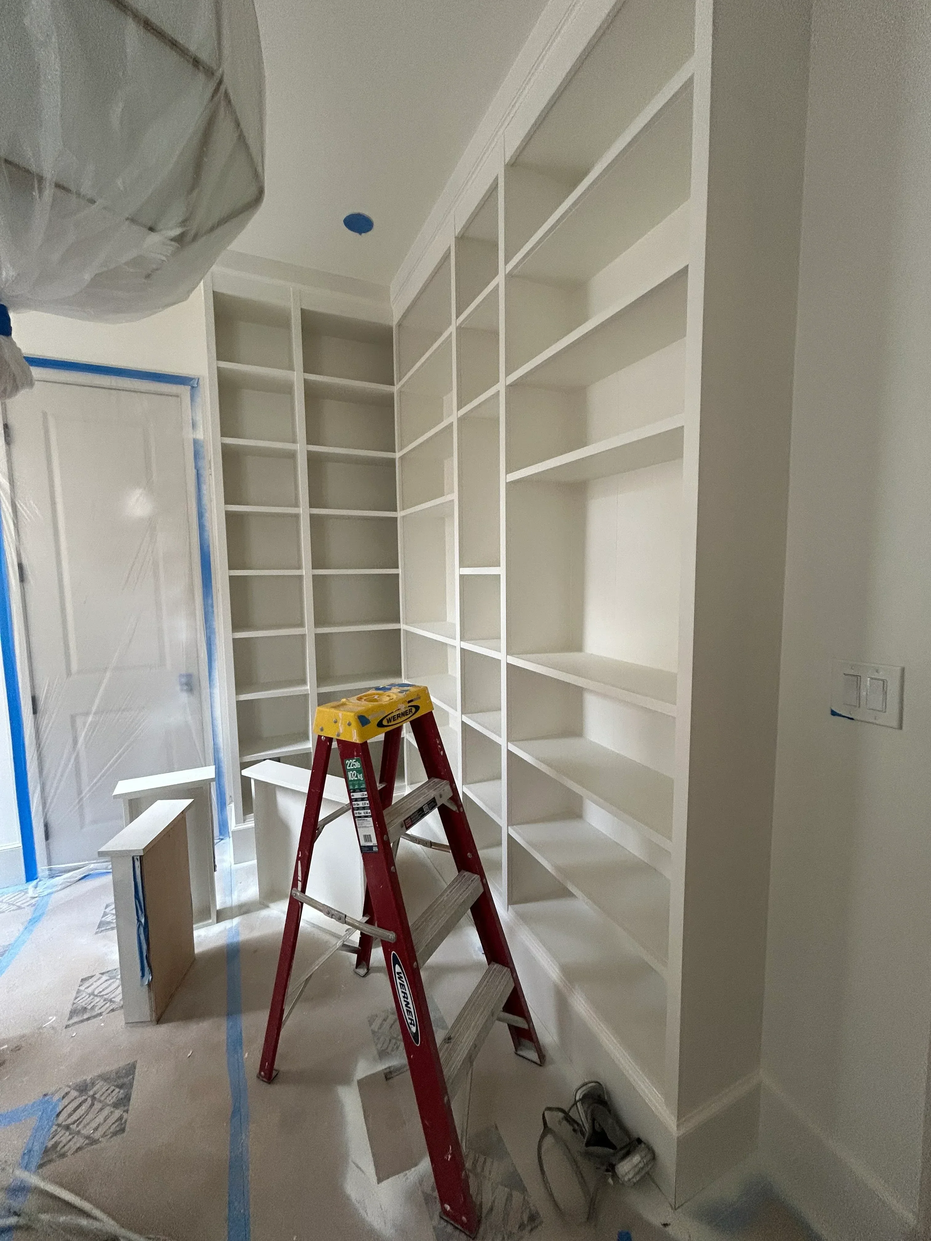 Finished drywall coffered ceiling with recessed sections and white primer coat