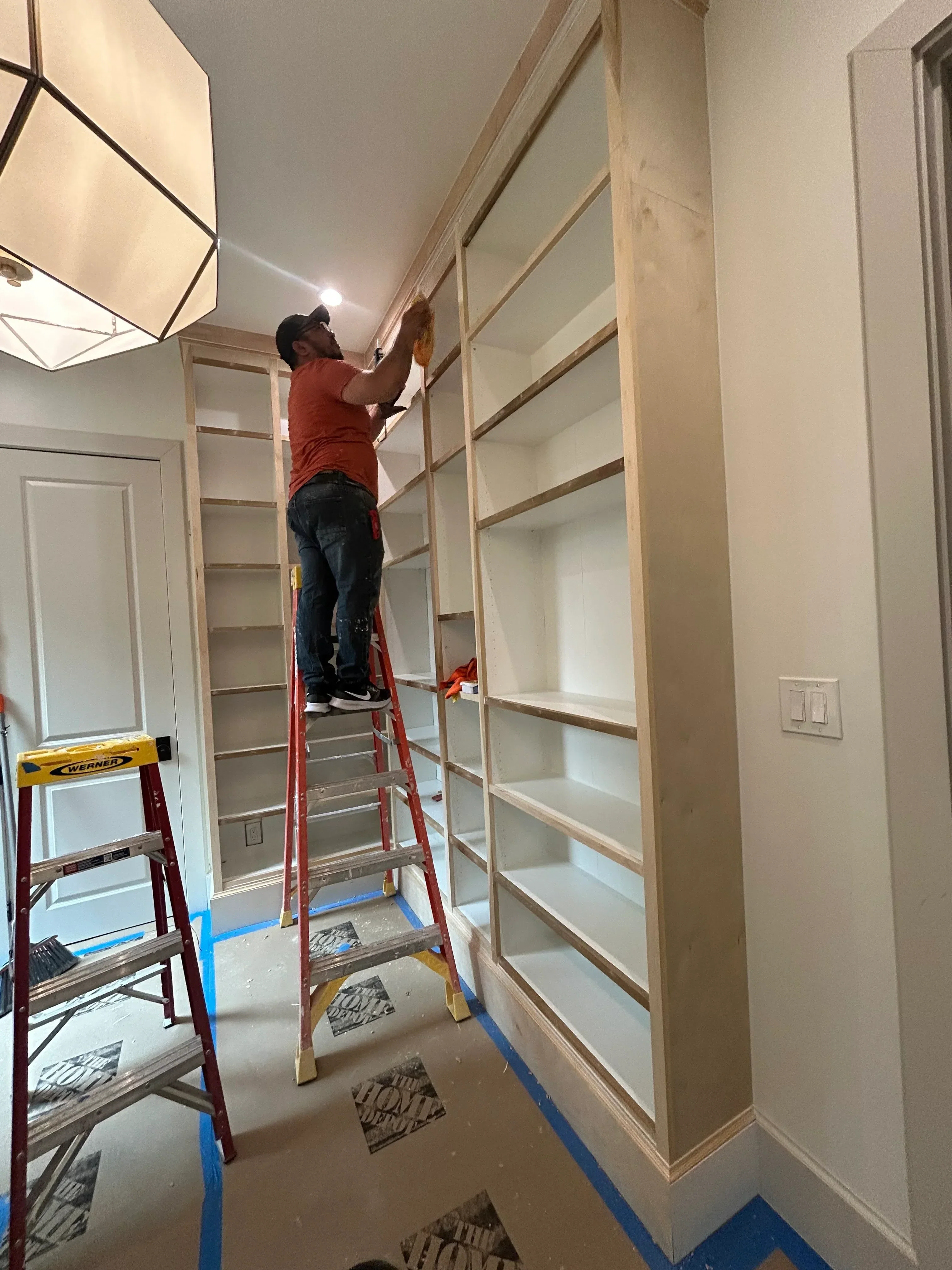 Drywall ceiling installation with taped seams and wooden framing structure