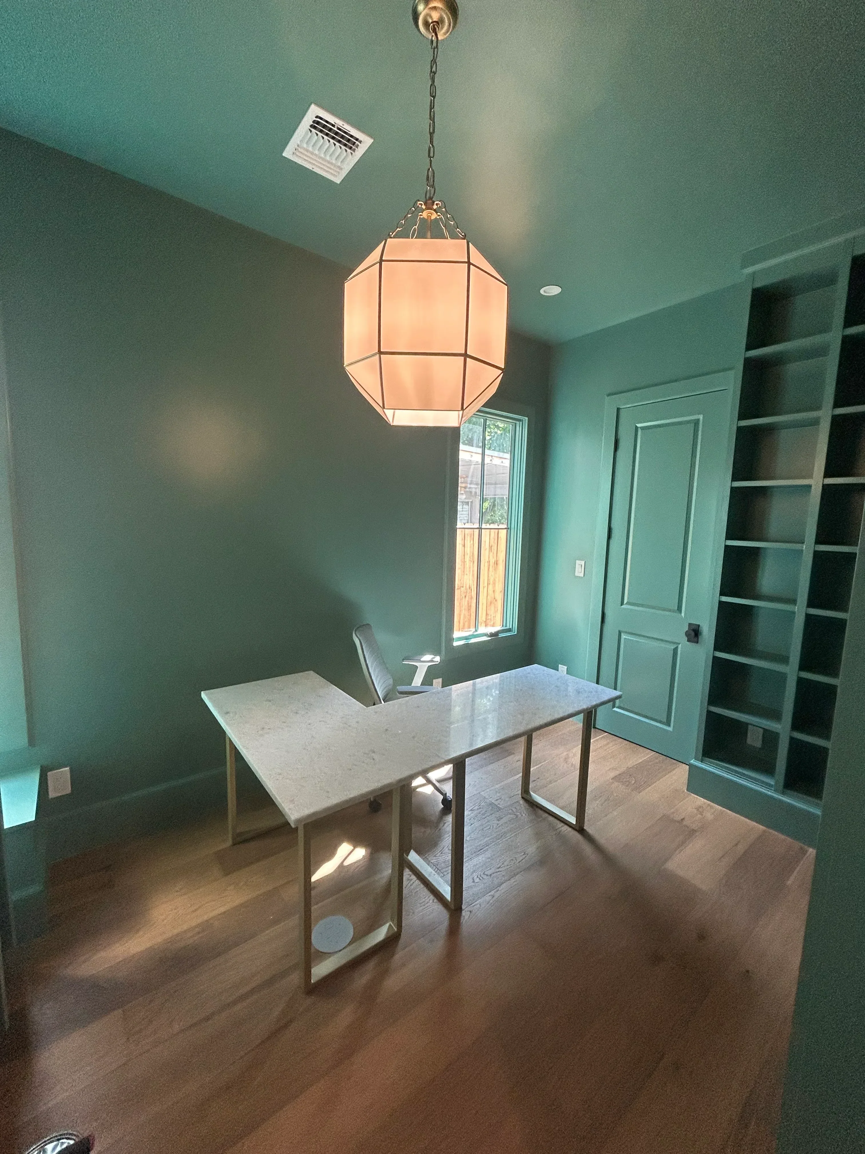 Sage green painted walls with white trim, door, and ceiling in residential interior space
